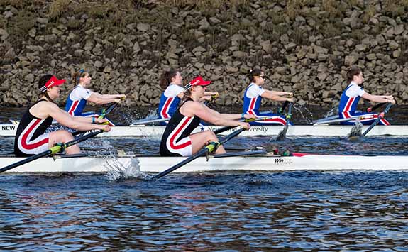 Two boats taking part in a rowing race. 